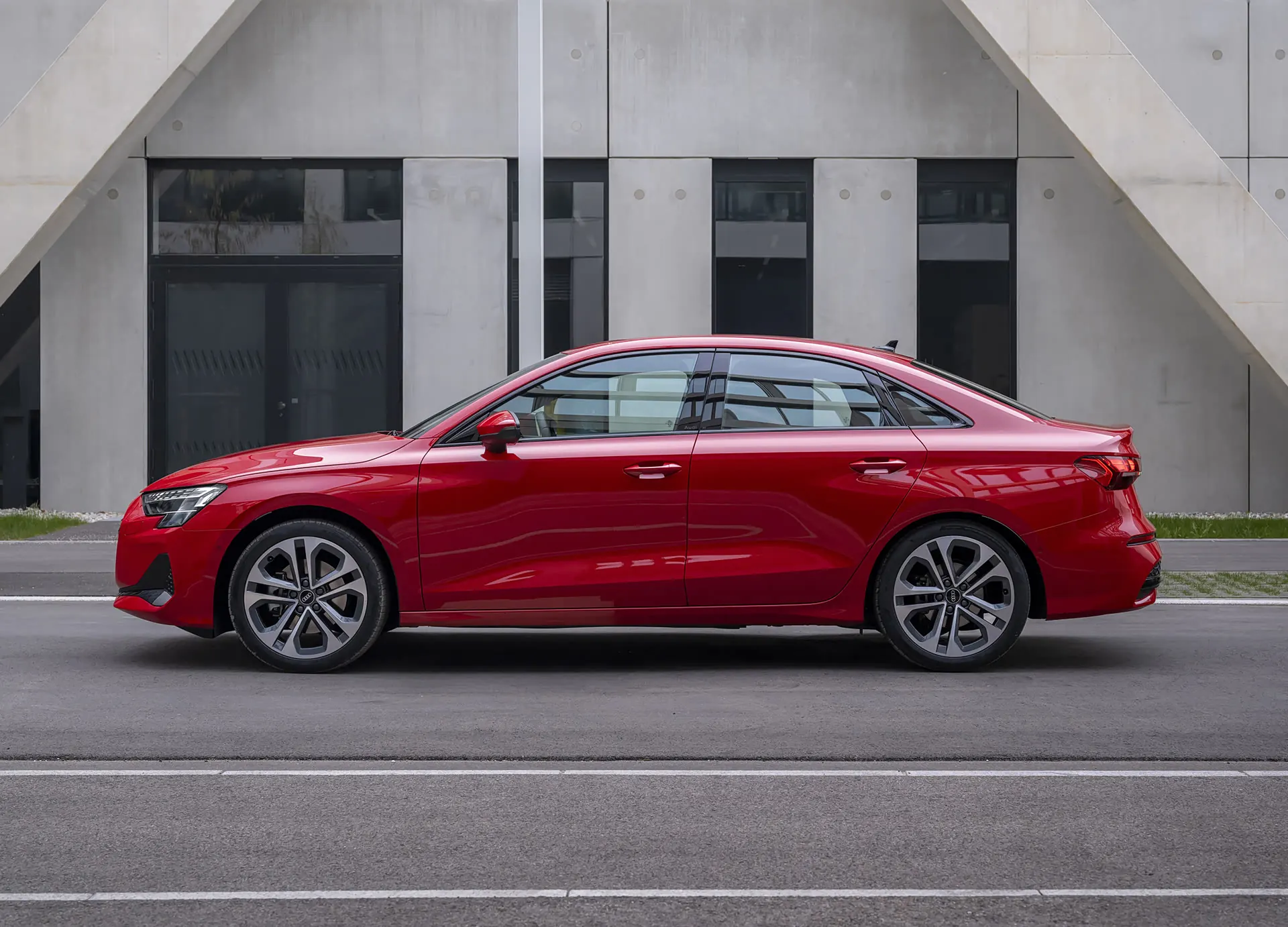 Audi A3 sedan in red, side profile